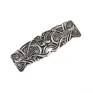 Macro detail of vintage silver-tone hair clip featuring ornate Celtic filigree patterns
