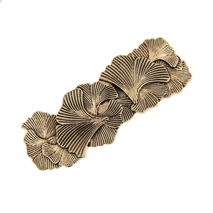 Macro view of vintage bronze leaf hair clip with detailed ginkgo leaf textures