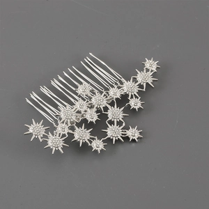 Macro shot of silver seven-tooth hair comb with rhinestones and flower details