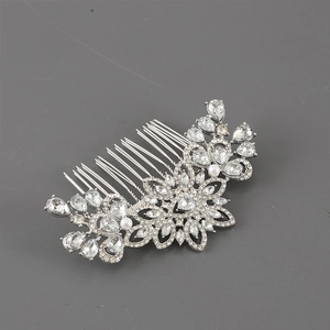 Detail of silver alloy hair comb with sparkling crystals and white pearls in floral design