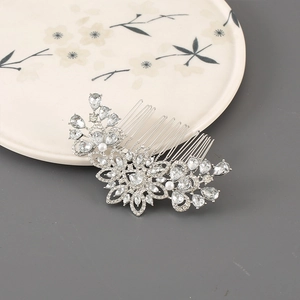 Macro detail of silver alloy floral hair comb with rhinestones and white faux pearls