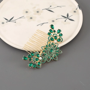 Detailed macro of gold flower hair comb with emerald crystals and pearls