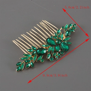Vintage gold hair comb with green rhinestones and leaf design measuring 3.9 inches long
