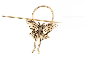 Detailed macro view of vintage butterfly hair pin made of aged gold finish alloy