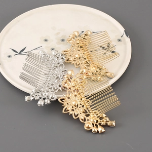Close-up of three crystal flower hair combs in gold and silver finish on a ceramic plate