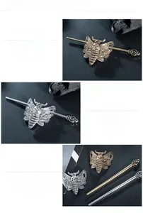 Macro shot of polished alloy moth skull hair pins with mirror finish and spiral detailing