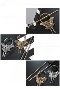 Detail of vintage insect hairpins with intricate moth wing textures in gold and silver finish