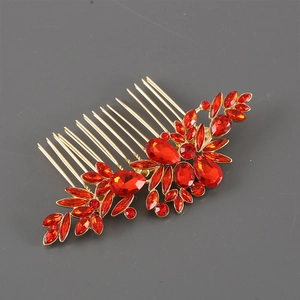 Detail of vintage gold alloy hair comb featuring intricate red crystal flower clusters