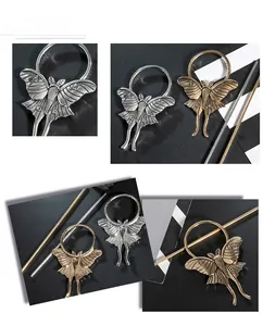 Detailed macro view of vintage gothic moth hairpins in antique silver and bronze metal finish