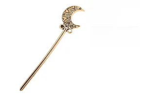 Detailed close-up of crescent moon alloy hair stick with hollow vintage patterns
