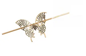 Close-up of a hollow-out butterfly hair stick in vintage gold finish with detailed metalwork