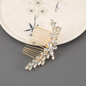 Detailed macro view of golden flower hair comb with zircon leaf ornaments for weddings