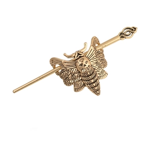 Close-up of vintage gothic skull moth hair pin in antique gold metal finish