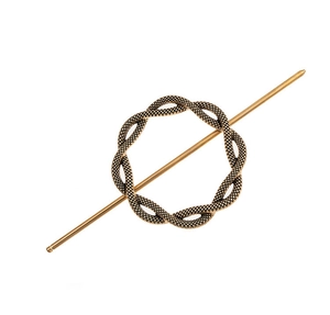 Close-up of vintage bronze alloy hair pin with woven circular ring and minimalist stick