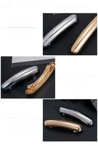 Close-up of minimalist gold and silver metallic hair clips with polished mirror finish