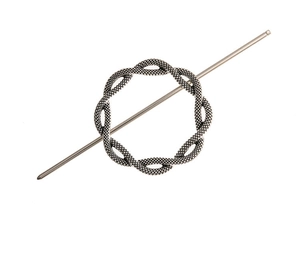 Detail of vintage silver hair pin featuring a twisted rope circle and metal stick