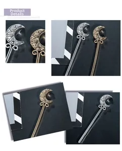 Macro detail of crescent moon hair pins with mandala patterns in gold and silver finish