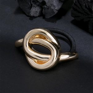 Minimalist golden double loop knotted hair tie with polished metal finish on black background