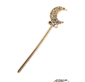 Detail of crescent moon hair pin showing intricate bohemian mandala patterns in bronze gold