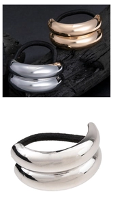 Detail of minimalist gold and silver polished metal geometric hair ring accessories