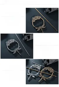 Detail of dragonfly and sunflower hair pin with mirror polished gold and silver finish