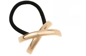Macro detail of alloy hair tie featuring golden X-shaped geometric metal decoration
