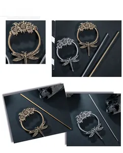 Macro view of sunflower and dragonfly hairpin in antique gold and silver finish