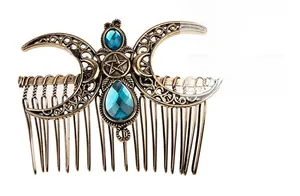 Detailed macro of vintage alloy hair comb with blue gems and star moon totem