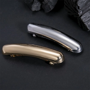 Minimalist metallic hair clips in gold and silver finish with high-gloss mirror texture