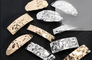 Detail of hammer textured gold and silver alloy hairpins with irregular geometric design