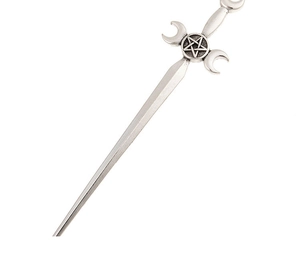Macro shot of silver alloy hair stick featuring triple moon and pentagram gothic relief