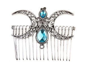 Detail of vintage silver alloy hair comb with triple moon and blue gemstones