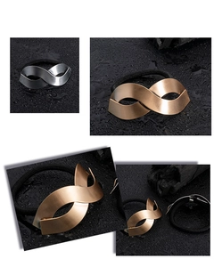 Detail view of infinity-shaped alloy hair ties in matte gold and silver finishes