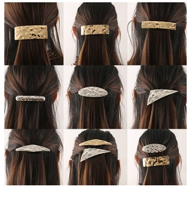 Detail of irregular geometric metal hair clips with hammered gold and silver textures
