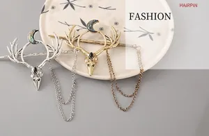Macro shot of silver and gold antler hairpins with alloy bird skull and crescent moon details