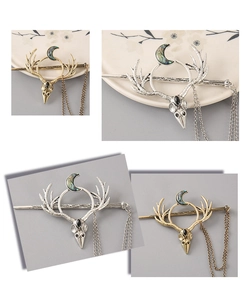 Macro detail of stag skull hairpins in gold and silver finish with moon pendants