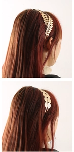 Detailed view of double-layered gold metal headbands with leaf and star coin designs