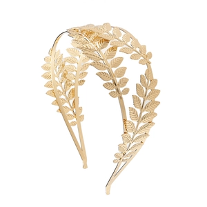 Vintage gold double leaf headband for women with detailed metallic foliage design