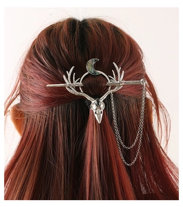 Gothic antler skull hair pin with moon crescent and metal tassels on reddish hair