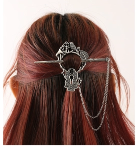 Detail of silver fantasy hair stick with bird, mushroom elements and tassel chains