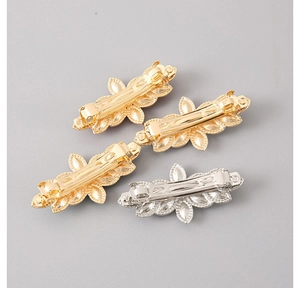 Detailed back view of alloy hair clips showing metallic spring lock mechanism and rhinestones
