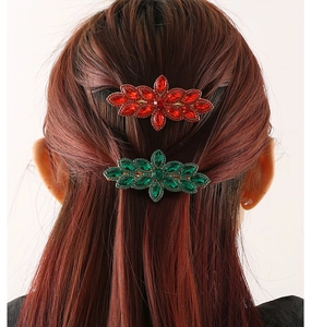 Rear view of a model wearing sparkling red and green rhinestone hair clips on dark hair