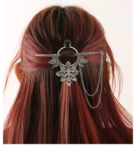 Detail of vintage silver maple leaf hair stick with black stone and hanging chains