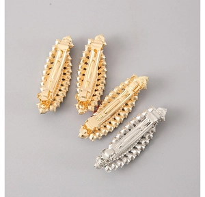 Detailed back view of four leaf-shaped metal hair clips with rhinestones in gold and silver