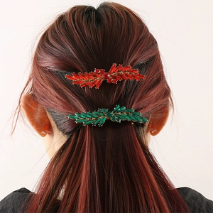 Sparkling leaf-shaped rhinestone hair clips in red and green colors on model hair