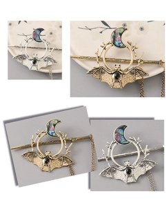 Detailed views of gothic bat hairpins with crescent moons, black gems and metal tassels