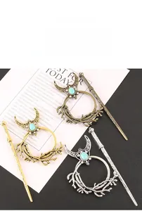 Detailed close-up of retro moon and vine hairpins with turquoise and white zircon stones