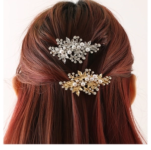 Detailed close-up of leaf-shaped alloy hair clip with pearls and rhinestones on hair