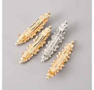 Detail view of the metal back mechanism and spring clip of zircon hairpins in gold and silver