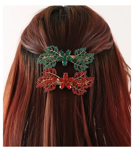Detail of crystal leaf hair clips in green and red colors on hair for elegant styling